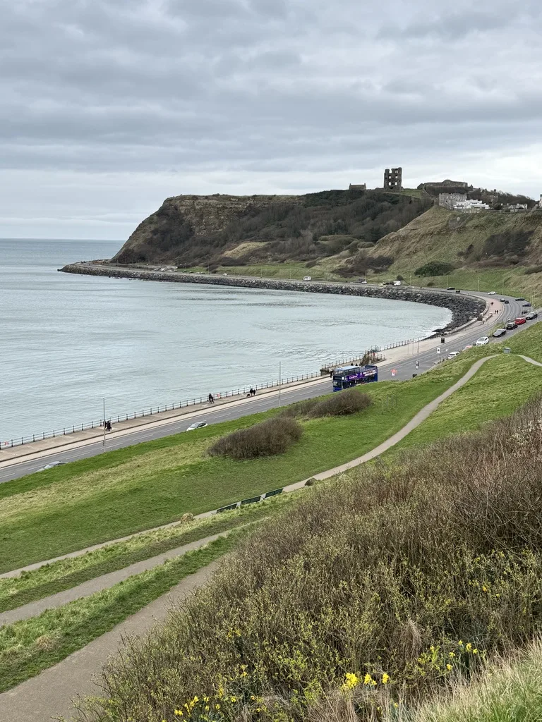 Scarborough Castle viewed from North Bay cliffs looking south along the Yorkshire coast