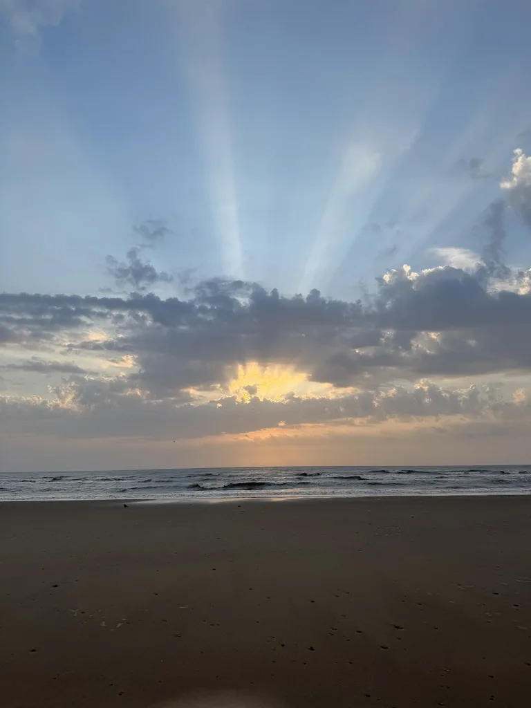 North Bay Scarborough sunrise over the beach with dramatic sky and sun rays across the Yorkshire coast