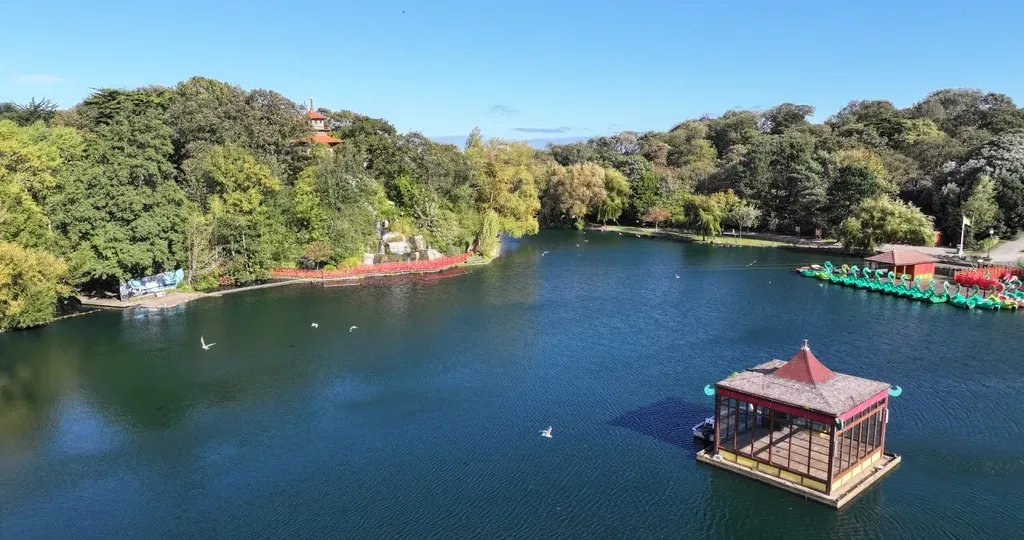 Peasholm Park lake in Scarborough with calm water, trees and island, a short walk from Seaside Hideaway Hotel