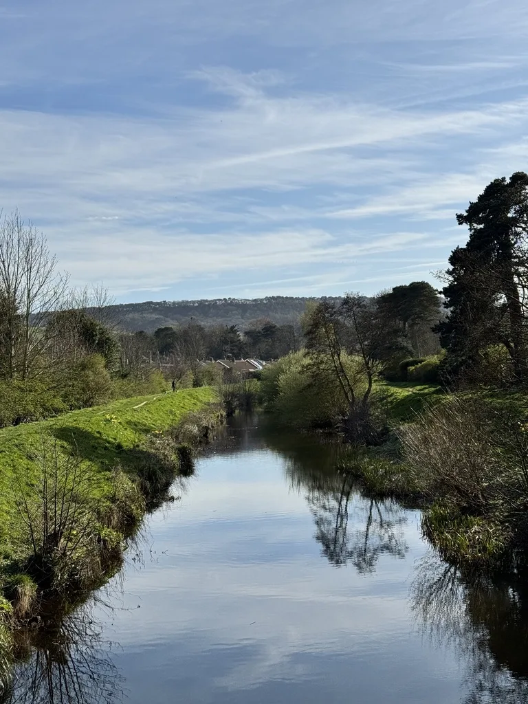Scalby Beck in Scarborough on a calm spring day with clear reflections and green countryside